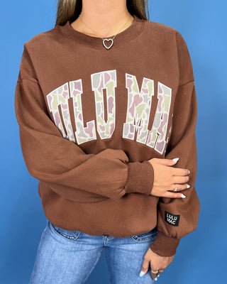 a brown crewneck sweatshirt with LULU MAC on sweatshirt.