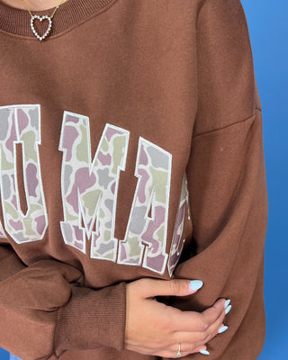 a brown crewneck sweatshirt with LULU MAC on sweatshirt.