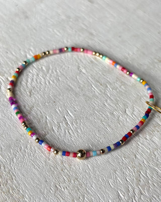 Colorful beaded necklace on a light gray background