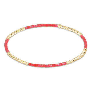 Bracelet with pink beads and gold accents on a white background