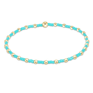 Beaded necklace with turquoise and gold beads on a white background