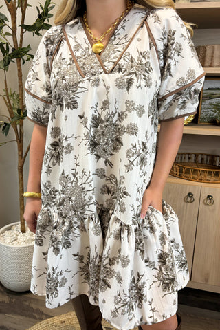 Woman wearing a floral dress in a casual setting
