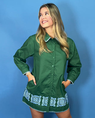 embroidered floral details, a collared button-front design, long sleeves