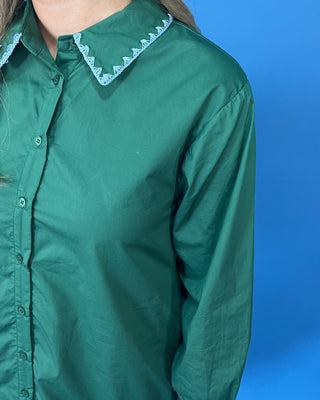 embroidered floral details, a collared button-front design, long sleeves