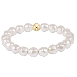 Pearl bracelet with a gold bead on a white background