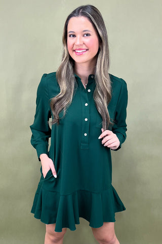 Woman wearing a green dress against a beige background