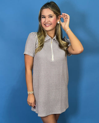 Brown and white gingham mini dress with puff sleeves, collared neckline, and front zipper detail.
