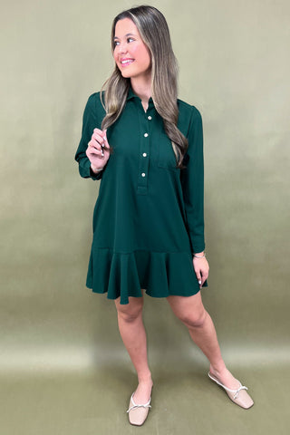 Woman wearing a green dress against a beige background