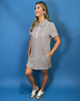 Brown and white gingham mini dress with puff sleeves, collared neckline, and front zipper detail.