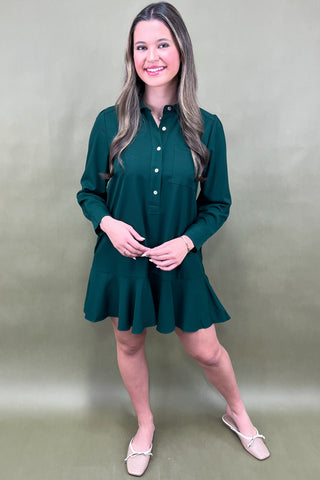 Woman wearing a green dress against a plain background