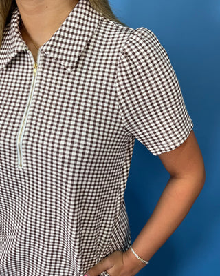 Brown and white gingham mini dress with puff sleeves, collared neckline, and front zipper detail.