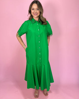 Woman wearing a green dress against a pink background
