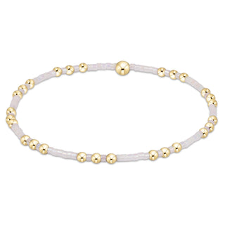 Bracelet with gold beads on a white background
