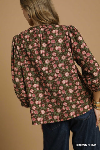 Floral patterned jacket worn by a person on a beige background
