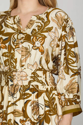 Floral patterned dress with brown and beige colors on a plain background