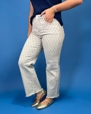 light gray patterned denim jeans with a textured geometric design