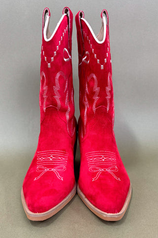Red cowboy boots with white embroidery on a gray background