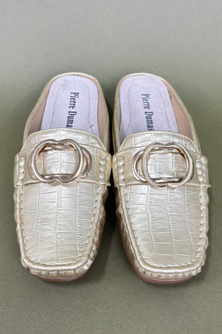 Pair of white loafers with metallic buckle on a gray background