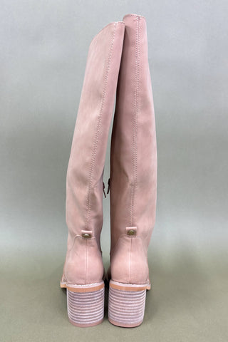 Pair of pink boots on a light gray background