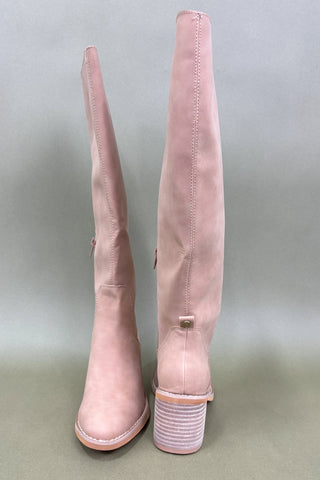 Pair of pink knee-high boots on a light gray background