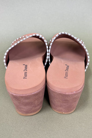 Pair of Pierre Dunand shoes with pink soles on a light gray background