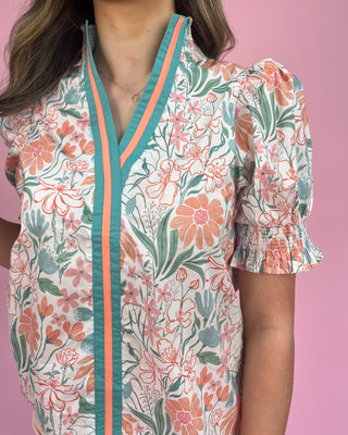 Floral patterned top with a pink background