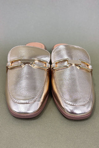 Pair of metallic loafers with gold accents on a gray background