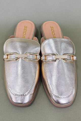 Pair of silver loafers with gold accents on a gray background