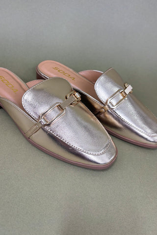Pair of metallic loafer shoes on a light gray background