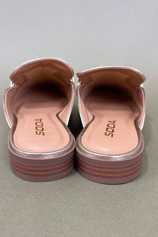Pair of pink sandals with 'SODA' branding on a gray background