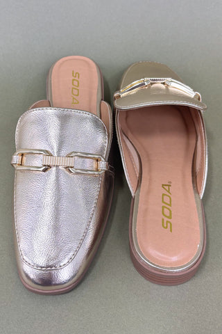 Metallic loafer and sandal with 'SODA' branding on a gray background