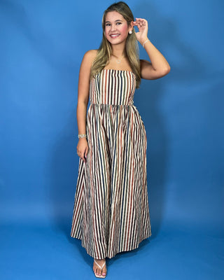 Strapless multicolor striped maxi dress with a fitted bodice, gathered waist, flowy skirt, and side pockets.
