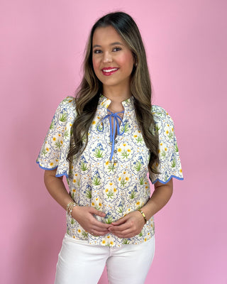 Woman wearing a floral blouse with a pink background