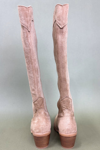Pair of pink suede knee-high boots on a light gray background