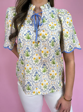 Woman wearing a floral patterned blouse with a pink background