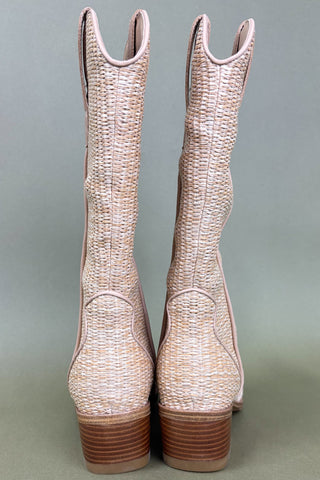 Pair of beige woven cowboy boots on a gray background