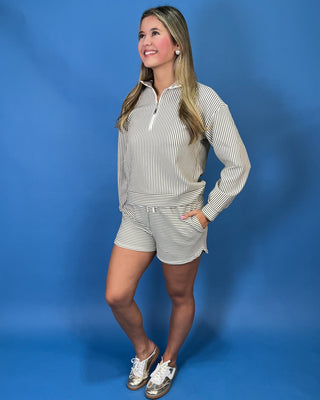 Cream and olive striped quarter zip shorts set with long sleeves, drawstring waist, and side pockets.