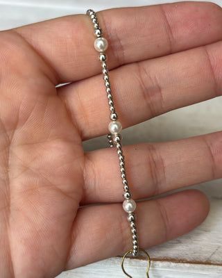 Pearl and silver beaded bracelet on a hand