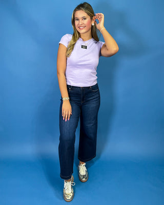 Lavender short sleeve LULU MAC top styled with dark wash high-rise wide leg cropped jeans.