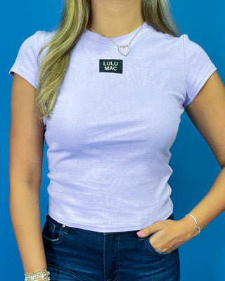 Lavender short sleeve LULU MAC top styled with dark wash high-rise wide leg cropped jeans.