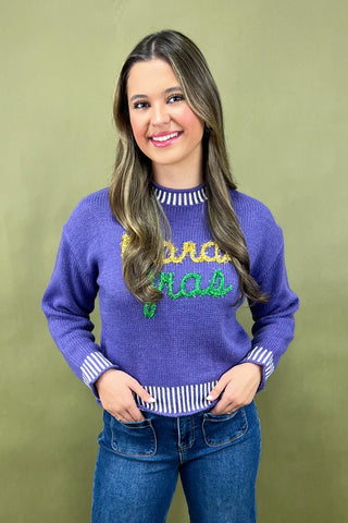 Woman wearing a purple sweater with text on a green background