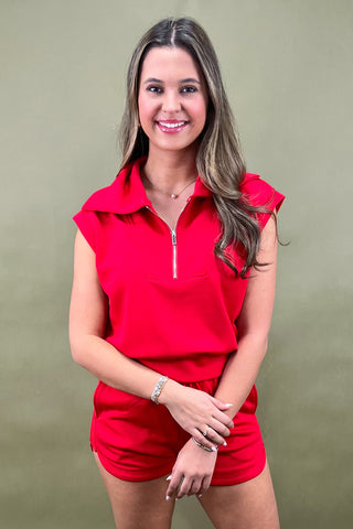 Woman wearing a red outfit with a green background