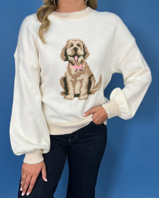 Ivory knit sweater with a cute dog graphic, pink bow detail, crew neckline, and relaxed fit.