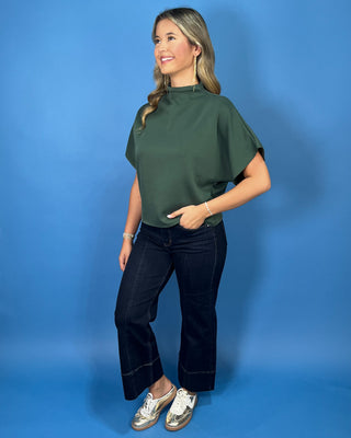 Hunter green mock neck top with relaxed short sleeves and a smooth, polished finish.