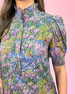 Multicolored floral patterned shirt on a pink background