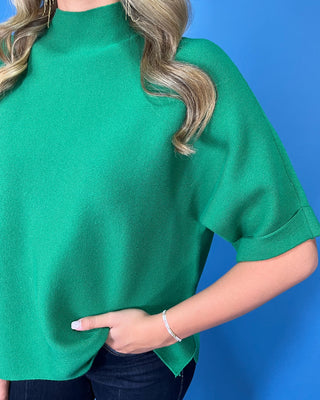Kelly green mock neck short sleeve sweater top with a relaxed fit and cuffed sleeves.