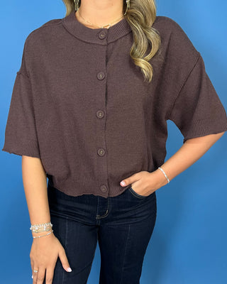 Chocolate brown short sleeve knit cardigan with button-front detail and a relaxed fit.