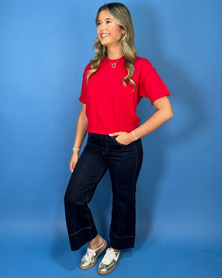 Bright red short sleeve knit sweater top with a crew neckline, ribbed trim, and relaxed fit.