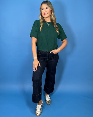 Hunter green short sleeve knit sweater top with a crew neckline, ribbed trim, and relaxed fit.
