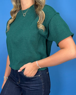 Hunter green short sleeve knit sweater top with a crew neckline, ribbed trim, and relaxed fit.